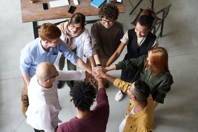 People uniting hands in an office